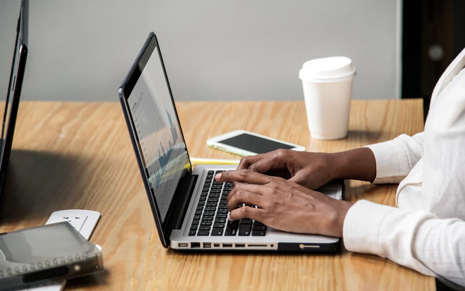 Editorial image for "Why Your Exit Plan Should Start Years Before the Exit". Source image: Woman working on a laptop.