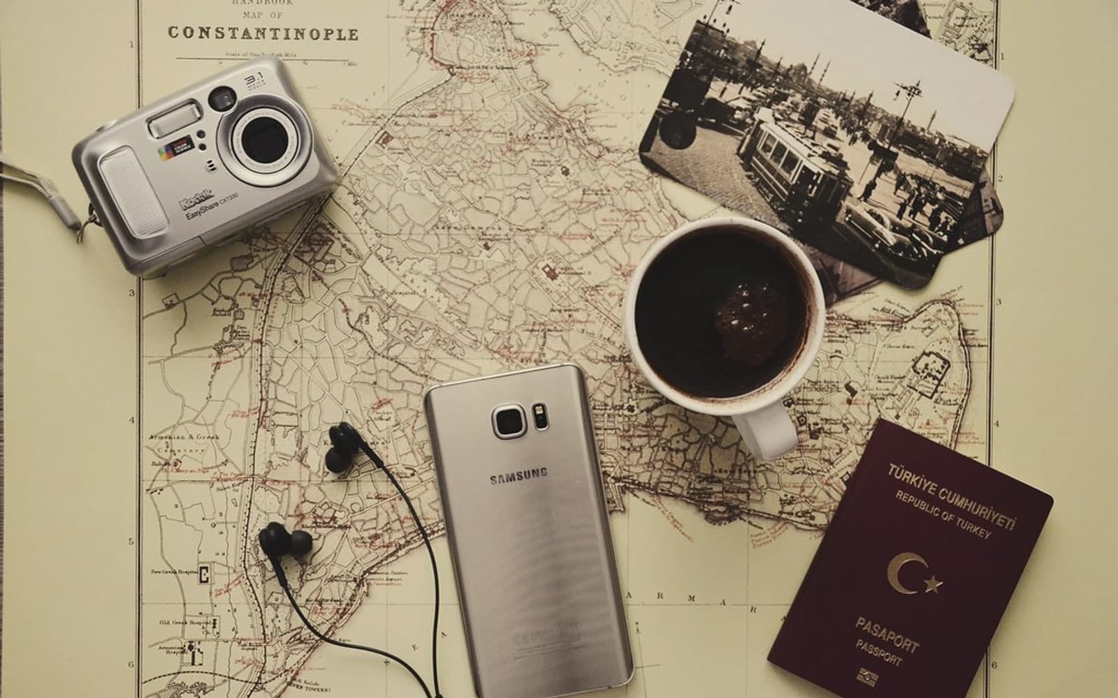 Editorial image for "The Wealth Nomad's First Principle: Your Life Is Global, But Your Advice Is Usually Local". Source image: silver-camera-near-black-coffee-in-mug-silver-samsung-galaxy-2305761.